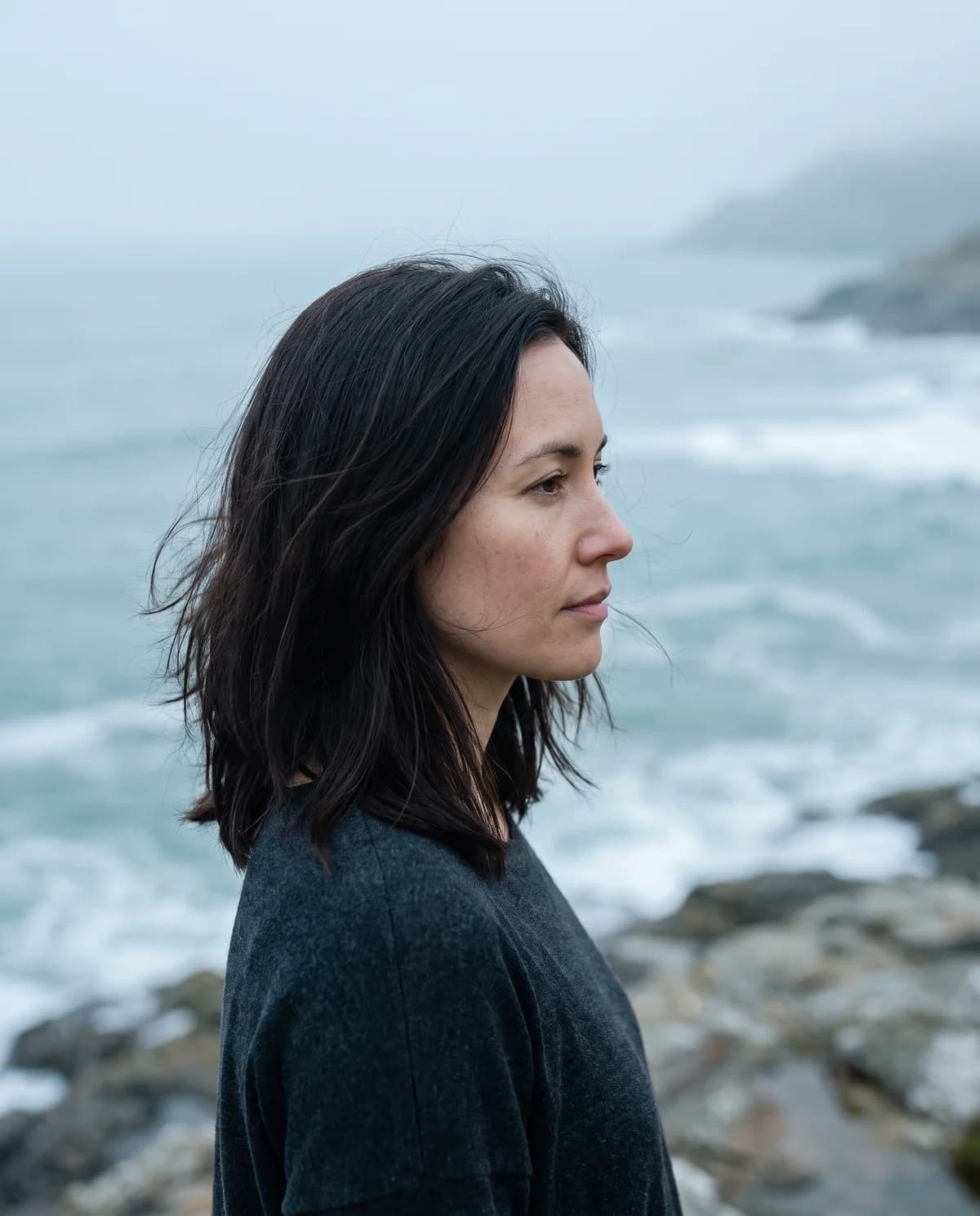A woman looking out over a misty sea
